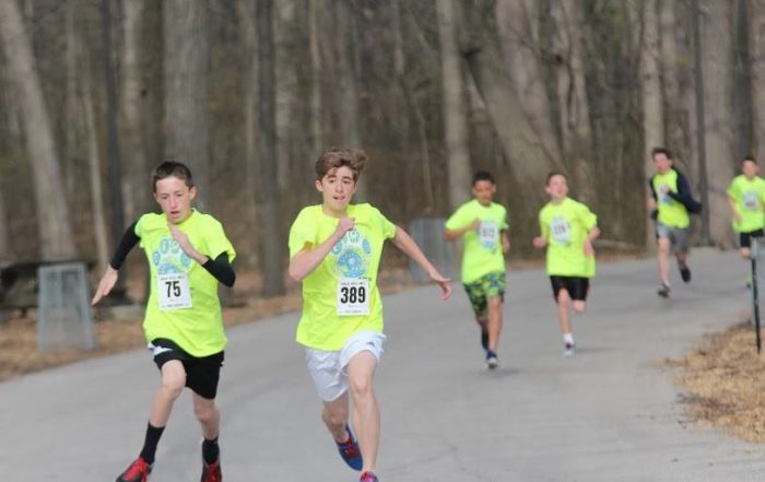 kids running a race in the woods